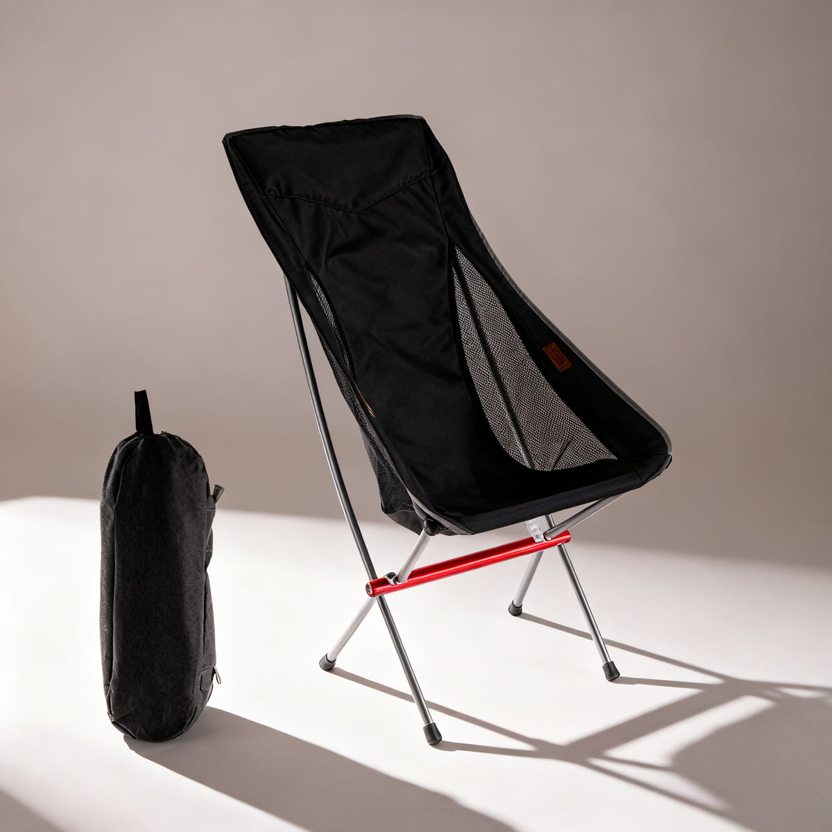 TrailPaw Heightened Moon Chair in Black with its carry bag