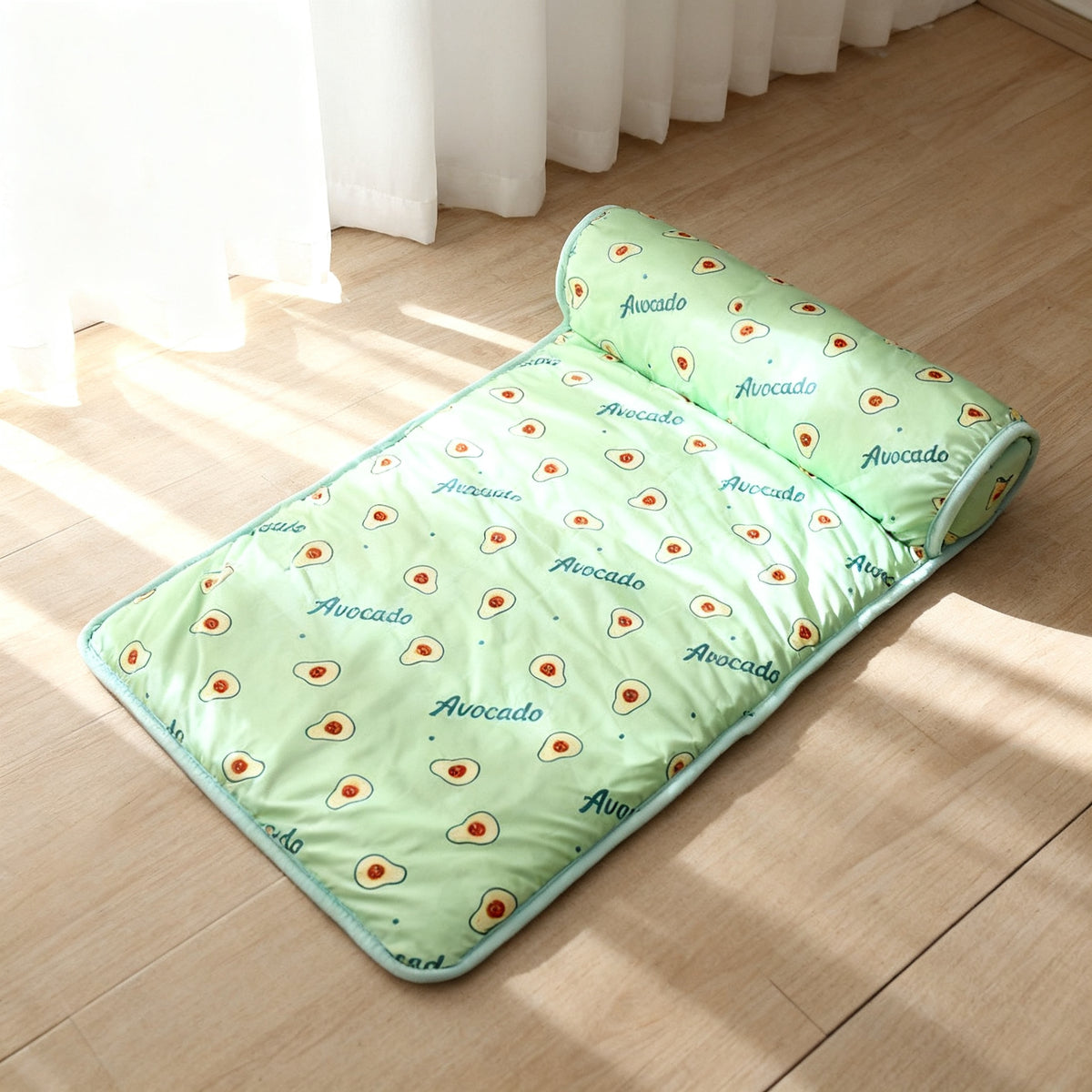 TrailPaw Ice Silk Bolster Pet Bed in the green avocado print, bolster pillow along one edge